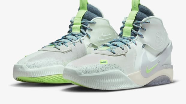 Side view of green and blue Nike shoes.
